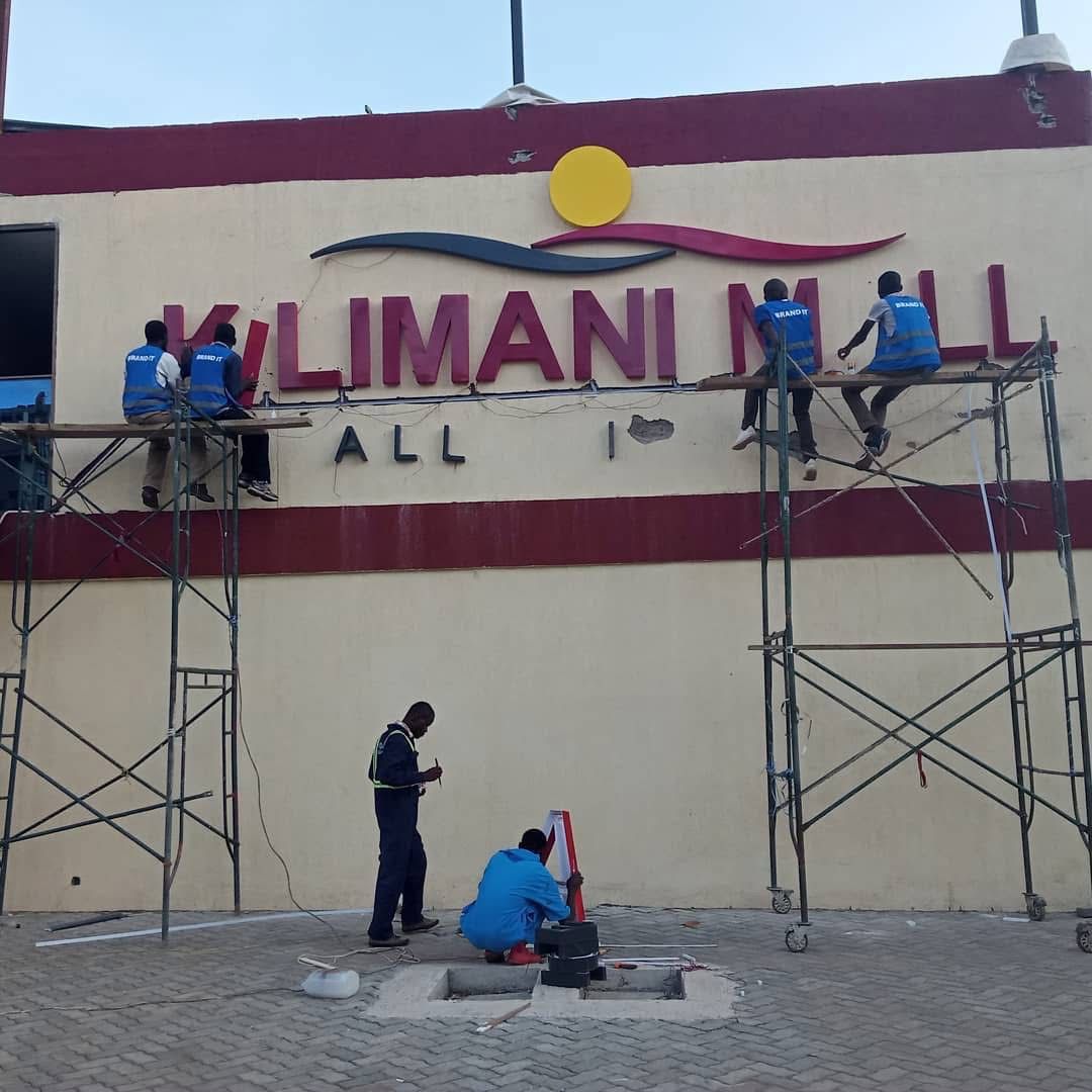 Brand It KE crew installing illuminated 3D letters on the Kilimani Mall fascia